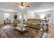 Bright living room featuring hardwood floors, a ceiling fan, and large windows at 3125 Leonard Dr, Gastonia, NC 28056