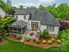 Home exterior featuring a screened-in porch and outdoor kitchen overlooking a manicured lawn at 3500 Maple Wood Dr, Denver, NC 28037