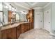 Luxurious bathroom with dual sinks, granite countertops, and custom cabinetry at 3500 Maple Wood Dr, Denver, NC 28037