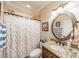 Bright bathroom with granite countertop, bronze fixtures, and shower/tub combination at 3500 Maple Wood Dr, Denver, NC 28037
