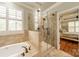 Bathroom featuring a glass-enclosed shower and soaking tub with tile surround at 3500 Maple Wood Dr, Denver, NC 28037