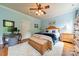 Bedroom featuring a queen sized bed, desk, side tables and blue decor elements at 3500 Maple Wood Dr, Denver, NC 28037