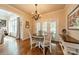 Cozy breakfast area with a chandelier, surrounded by natural light and a view to the backyard at 3500 Maple Wood Dr, Denver, NC 28037