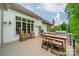 Inviting outdoor deck area with built-in grill, dining space, and charming string lights at 3500 Maple Wood Dr, Denver, NC 28037