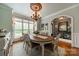 An inviting formal dining room with a decorative light fixture and ample natural light at 3500 Maple Wood Dr, Denver, NC 28037