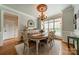 Formal dining room with chandelier, shuttered windows, and elegant decor at 3500 Maple Wood Dr, Denver, NC 28037