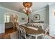 Dining room featuring wainscotting, decorative chandelier, and hardwood floors at 3500 Maple Wood Dr, Denver, NC 28037