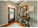 The entryway features a decorative door, wooden floors, console table, and lovely decor at 3500 Maple Wood Dr, Denver, NC 28037