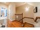 Hallway featuring wood floors and a decorative railing leading to the bedrooms at 3500 Maple Wood Dr, Denver, NC 28037