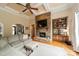 Living room featuring a stone fireplace, coffered ceiling, and hardwood floors at 3500 Maple Wood Dr, Denver, NC 28037