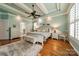 Bright primary bedroom with tray ceiling, hardwood floors, and ensuite bathroom entrance at 3500 Maple Wood Dr, Denver, NC 28037