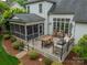 Outdoor kitchen and dining area with a built-in grill and screened in porch at 3500 Maple Wood Dr, Denver, NC 28037