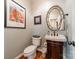 Stylish powder room featuring a vanity sink with wood cabinet and decorative mirror at 3500 Maple Wood Dr, Denver, NC 28037