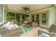 Inviting screened porch with woven furniture, a ceiling fan, and views of the wooded backyard at 3500 Maple Wood Dr, Denver, NC 28037