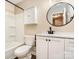 Traditional bathroom featuring a tub and shower combo, white cabinets, and a round mirror at 3572 Heather Ln, Gastonia, NC 28056