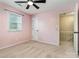 Pink bedroom featuring a window, ceiling fan, and neutral carpet at 3572 Heather Ln, Gastonia, NC 28056