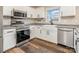 Bright kitchen features stainless steel appliances and a farmhouse sink below a large window at 3572 Heather Ln, Gastonia, NC 28056