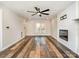 Spacious living room features a cozy fireplace, ceiling fan, and durable flooring at 3572 Heather Ln, Gastonia, NC 28056