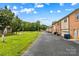 Street view of backyards of homes with mature trees and green grass at 402 Swaim Ct, Salisbury, NC 28147