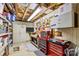 Unfinished basement workshop area offers storage cabinets, pegboard, and tool chests, ideal for projects at 402 Swaim Ct, Salisbury, NC 28147