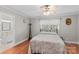 Cozy bedroom featuring hardwood floors, a ceiling fan, and an inviting floral comforter at 402 Swaim Ct, Salisbury, NC 28147
