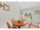 Inviting dining area with wooden table, window view, and hardwood flooring at 402 Swaim Ct, Salisbury, NC 28147