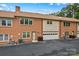 Brick townhome with garage and well-manicured landscaping, offering curb appeal and convenient parking at 402 Swaim Ct, Salisbury, NC 28147