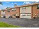 Rear view of townhome featuring a garage and asphalt driveway at 402 Swaim Ct, Salisbury, NC 28147