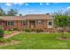 Lovely brick home with a neatly kept lawn, vibrant flowerbeds, and a charming pathway leading to the entrance at 402 Swaim Ct, Salisbury, NC 28147