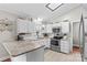 Well-lit kitchen with white cabinetry, stainless steel appliances, and tile backsplash at 402 Swaim Ct, Salisbury, NC 28147