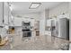 Bright kitchen featuring granite countertops and stainless-steel appliances and white cabinetry at 402 Swaim Ct, Salisbury, NC 28147