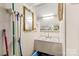 Unfinished laundry room with basin, mirror, storage shelf, and painted white walls at 402 Swaim Ct, Salisbury, NC 28147