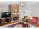 Inviting living room with a brick fireplace, ceiling fan, hardwood floors, and comfortable furnishings at 402 Swaim Ct, Salisbury, NC 28147