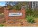 Community entrance sign for Castewood, showcasing brick pillars, lush greenery, and an inviting neighborhood feel at 402 Swaim Ct, Salisbury, NC 28147