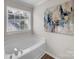 Bright bathroom featuring a soaking tub, window, and elegant wall art, providing a relaxing space at 4113 Edgeview Dr, Indian Trail, NC 28079
