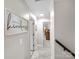 Hallway with neutral walls, white trim, and gray carpet leads to various rooms at 4113 Edgeview Dr, Indian Trail, NC 28079