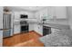 Bright kitchen with stainless steel appliances, granite countertops, and ample white cabinetry at 4113 Edgeview Dr, Indian Trail, NC 28079