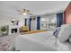 Spacious bedroom with a fireplace, ceiling fan, blue curtains, and a seating area with ample natural light at 4113 Edgeview Dr, Indian Trail, NC 28079