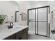 Modern bathroom featuring a sleek vanity, white subway tiles in shower, and a black-framed glass shower door at 433 Sinaloa St, Waxhaw, NC 28173