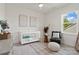 Cozy bedroom with a crib, stylish accent chair, and natural light, perfect for a comfortable and serene Bedroom at 433 Sinaloa St, Waxhaw, NC 28173