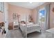 Charming pink bedroom with a bed, natural light, and stylish decor creating a cozy and inviting atmosphere at 433 Sinaloa St, Waxhaw, NC 28173