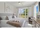 Bright bedroom with a large window, soft neutral tones, and a cozy sitting area with an accent chair at 433 Sinaloa St, Waxhaw, NC 28173