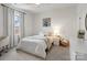 Bright bedroom featuring a ceiling fan, large window, and a bed with decorative pillows at 433 Sinaloa St, Waxhaw, NC 28173