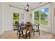 Dining area with hardwood floors, glass table, contemporary lighting, and view of the outdoors at 433 Sinaloa St, Waxhaw, NC 28173