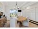 Bright dining room featuring a modern chandelier, wood floors, and views of the neighborhood at 433 Sinaloa St, Waxhaw, NC 28173