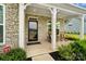 Inviting front porch with stone columns and rocking chairs, creating a relaxing outdoor space at 433 Sinaloa St, Waxhaw, NC 28173