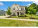 Charming home with stone accents, a welcoming porch, and a beautifully landscaped front yard at 433 Sinaloa St, Waxhaw, NC 28173