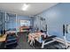 Home gym with weightlifting equipment and a play area, featuring a rubber floor for safety at 433 Sinaloa St, Waxhaw, NC 28173