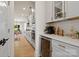 Modern kitchen with sleek gray cabinets, stainless steel appliances, wine cooler, and hardwood flooring at 433 Sinaloa St, Waxhaw, NC 28173