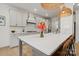 Bright kitchen island with a white countertop, gray base, hardwood floors, and stainless steel appliances at 433 Sinaloa St, Waxhaw, NC 28173